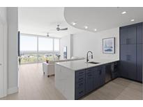 Modern kitchen with white quartz island and dark blue cabinetry at 3325 Piedmont Rd # 2203, Atlanta, GA 30305