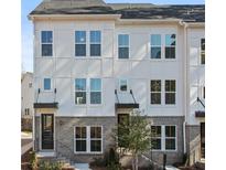 Modern townhome with white siding and stone accents at 2506 Astaire Ct, Atlanta, GA 30318