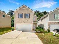 Two-story brick home with attached garage at 1054 Valley Rock Dr, Lithonia, GA 30058