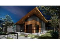 Modern home exterior with wood and metal siding at night at 6305 Shannon Parkway # 206, Union City, GA 30291