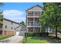 Two-story house with gray siding, large windows, and a two-car garage at 131 Bowen Sw Cir, Atlanta, GA 30315