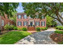 Brick two-story home with manicured lawn and circular driveway at 3444 Paces Ferry Cir, Smyrna, GA 30080