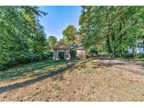 Cozy ranch-style house with a front yard and driveway at 276 Thompson St, Alpharetta, GA 30009
