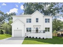 Two-story white brick home with attached garage and landscaped lawn at 3220 Ridgecrest Se Rd, Smyrna, GA 30080