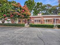 Brick townhouse with screened porch and ample parking at 309 Quail Run, Roswell, GA 30076