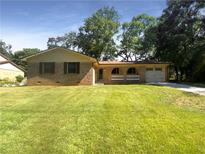 Brick ranch house with a carport, porch, and well-maintained lawn at 4128 Snapfinger Way, Decatur, GA 30035
