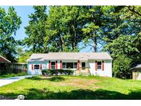 Charming white brick ranch home with red shutters, landscaped lawn, and a long driveway at 1907 Clarke Ln, Decatur, GA 30035