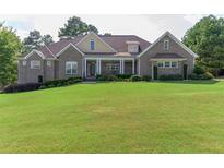 Brick home with a large lawn and 3 car garage at 158 Watkins Glen Dr, Mcdonough, GA 30252