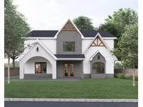 Two-story home features a stone and white exterior, a gabled roof, and landscaping at 474 Eastland Dr, Decatur, GA 30030