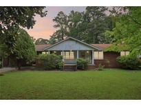 Brick ranch house with a front porch and large yard at 1272 Breezy Ne Ln, Atlanta, GA 30329
