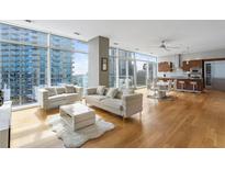 Modern living room with hardwood floors and city views at 45 Ivan Allen Jr. Nw Blvd # 2501, Atlanta, GA 30308