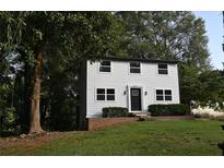 Two-story white house with black door and windows, landscaped yard at 5180 Stone Trce, Stone Mountain, GA 30083