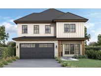 Two story house with dark garage door and light colored exterior at 2884 Thompson Cir, Decatur, GA 30034
