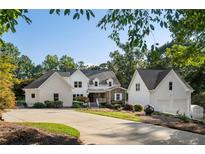 Two-story white farmhouse with a stone facade at 1095 Mockingbird Ln, Cumming, GA 30041