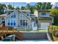 Two-story townhome with a landscaped yard and attached garage at 1666 Paddlewheel Dr, Marietta, GA 30062