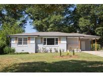 Charming ranch home with gray brick exterior and landscaped yard at 2790 Miriam Ln, Decatur, GA 30032