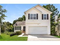 Two-story house with attached garage and front yard at 6635 Shapiro Ct, Stone Mountain, GA 30087
