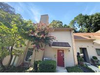 Townhouse exterior with red door and landscaping at 3805 Stonewall Se Ter # 3805, Atlanta, GA 30339