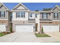 Two-story townhome with attached garage and landscaping at 174 Hampton Cir, Mcdonough, GA 30253