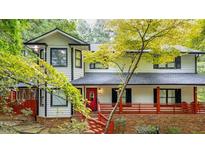 Two story house with white siding, red porch, and landscaping at 4901 Giles Nw Rd, Acworth, GA 30101