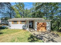 Updated Ranch home with a modern garage door at 1985 Cummings Sw Dr, Atlanta, GA 30311