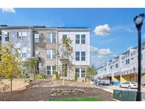 Modern three-story townhome with brick and siding exterior, showcasing a landscaped front yard at 1925 Rogers Ct, Atlanta, GA 30318