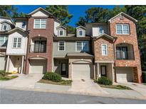 Three townhouses with brick and stone exterior at 2986 Ashlyn Pointe Dr, Atlanta, GA 30340