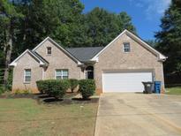 Brick ranch home with a two-car garage and landscaping at 3475 Washington Rd, Atlanta, GA 30344