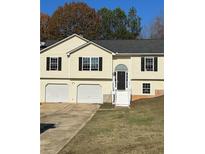 Two-story house featuring a two-car garage and a neat lawn at 212 Jordan Ln, Carrollton, GA 30116