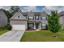 Two-story home with brick facade and attached garage at 1068 W Union Grove Cir, Auburn, GA 30011