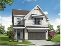 Two-story farmhouse style home with gray garage doors and white siding at 615 Skytop Dr, Cumming, GA 30040