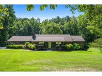 Ranch style home with large yard and mature trees at 725 Holland Rd, Powder Springs, GA 30127
