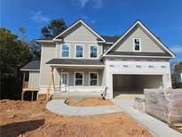 Two-story home with a large front yard and attached garage at 303 Retreat Way, Carrollton, GA 30116