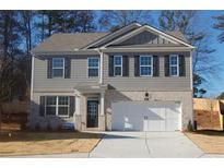 Two-story house with gray siding, white garage door, and landscaping at 6103 Zephyr E Ln, Mableton, GA 30126