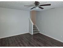 Living room featuring hardwood floors and a staircase at 500 Mica Trce, South Fulton, GA 30349