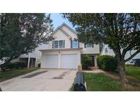 Two story home with double garage and mature landscaping at 3008 Summer Breeze Dr, Villa Rica, GA 30180