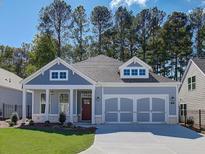 Charming craftsman style home with gray siding, a red door and two-car garage at 170 Harvest Trl, Hiram, GA 30141