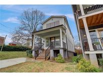 Two story home with front porch and landscaping at 975 Welch Sw St, Atlanta, GA 30310