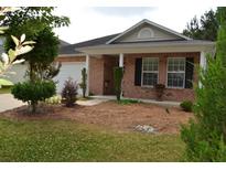 Brick ranch house with a covered porch and well-manicured landscaping at 1007 Sycamore Ln, Villa Rica, GA 30180