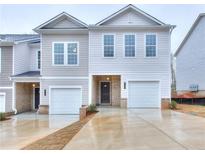 Two-story townhome with neutral siding, double garages, and a shared driveway at 3409 Ripple Loop # 126, South Fulton, GA 30349