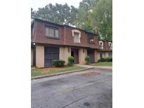 Condo building exterior, brown roof, tan siding, landscaping, and parking at 2968 Parc Lorraine, Lithonia, GA 30038