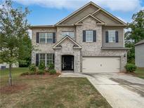 Two-story brick home with a large yard and attached garage at 368 Madison Grace Ave, Mcdonough, GA 30252