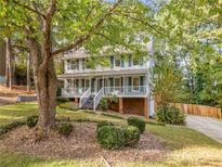 Two story house with front porch and landscaped yard at 1073 Boston Rdg, Woodstock, GA 30189