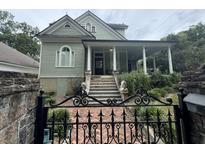Charming two-story home with ornate gate at 490 Hill Se St, Atlanta, GA 30312