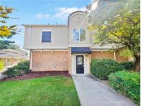 Two-story townhome with brick facade and manicured lawn at 3301 Henderson Mill Rd # Z1, Atlanta, GA 30341