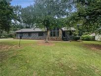 House exterior showcasing a ranch style home with a large yard at 3551 Mill Glen Dr, Douglasville, GA 30135