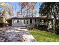 Ranch-style home with gray siding and a green lawn at 2072 Clairmont Ter, Atlanta, GA 30345