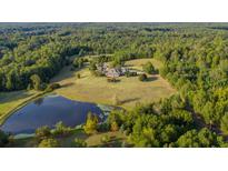 Aerial view of house, expansive lawn, and pond at 1473 Highway 85 Connector, Brooks, GA 30205