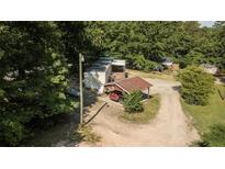 Aerial view of a mobile home on a wooded lot with a carport at 64 Luther Knight Se Rd, Cartersville, GA 30121