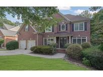 Two-story brick house with a double-car garage at 8033 Allerton Ln, Cumming, GA 30041